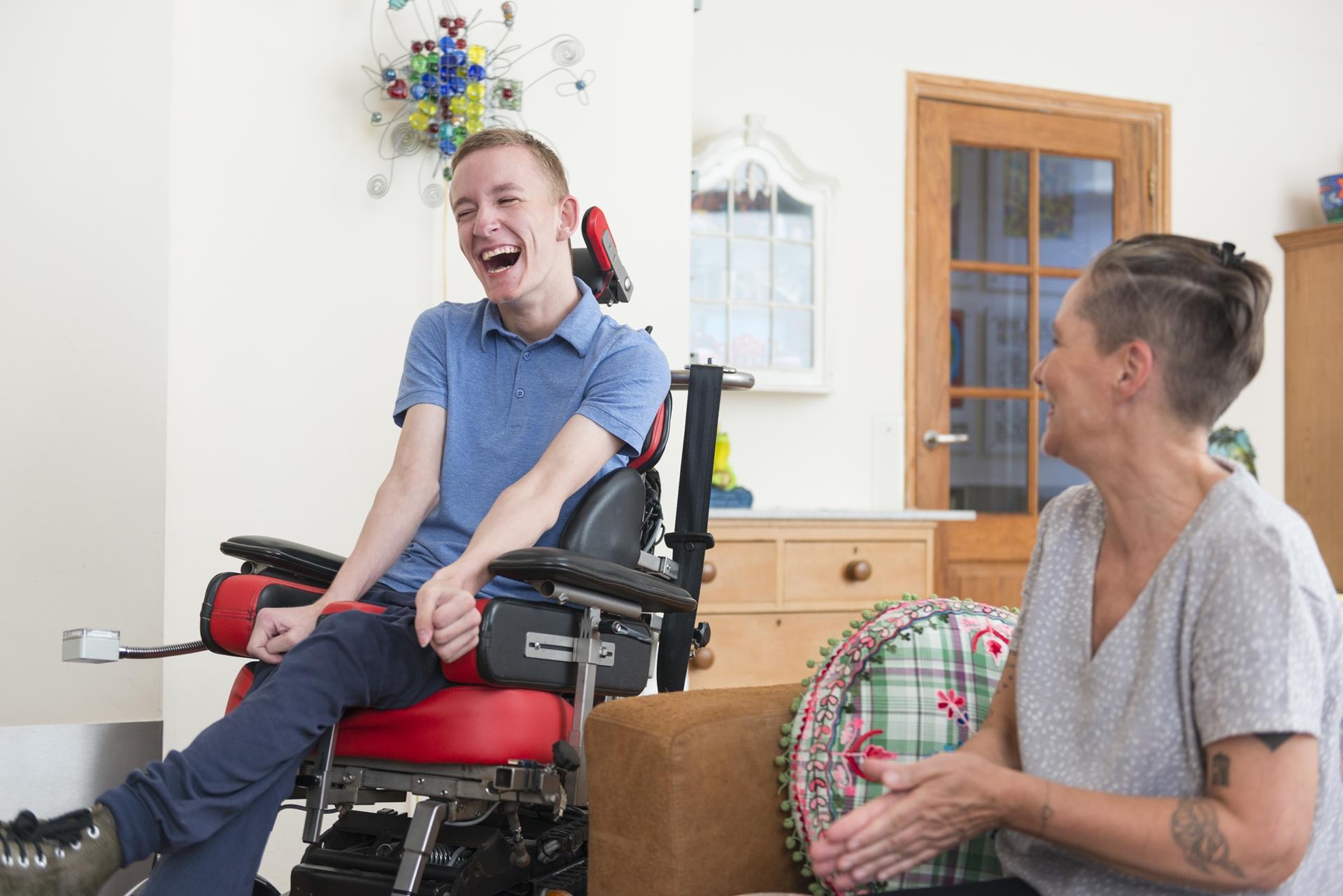 teenage in motorized wheelchair laughing - estrella home health